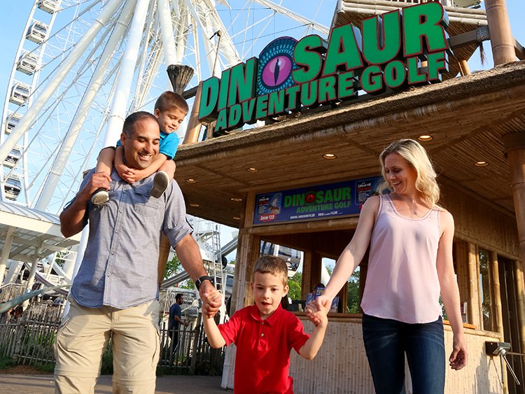 Family In Front of SkyWheel and Dino Park