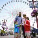 Family enjoying ice cream On Clifton Hill in front of SkyWheel
