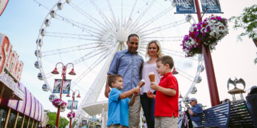 Family enjoying ice cream On Clifton Hill in front of SkyWheel