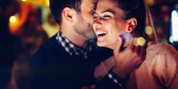 Romantic couple dating in pub at night