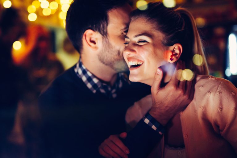 Romantic couple dating in pub at night