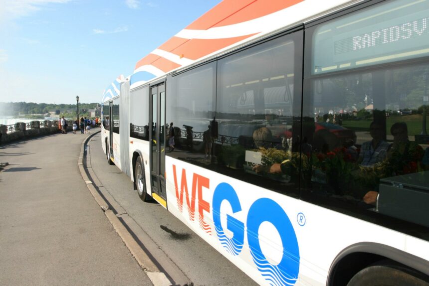 Wego Bus at Daytime on the Niagara Parkway with Falls in background