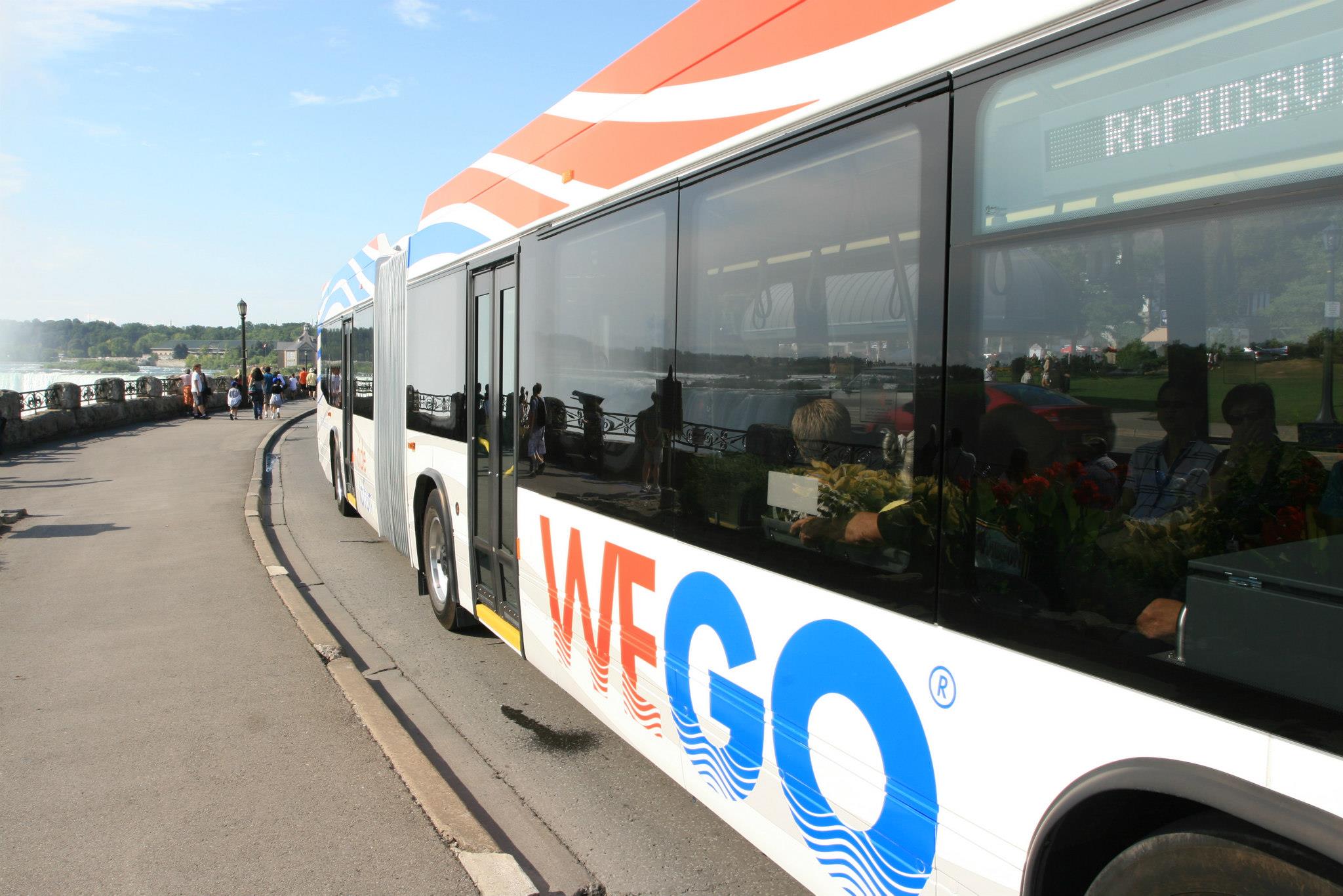 Wego Bus at Daytime on the Niagara Parkway with Falls in background