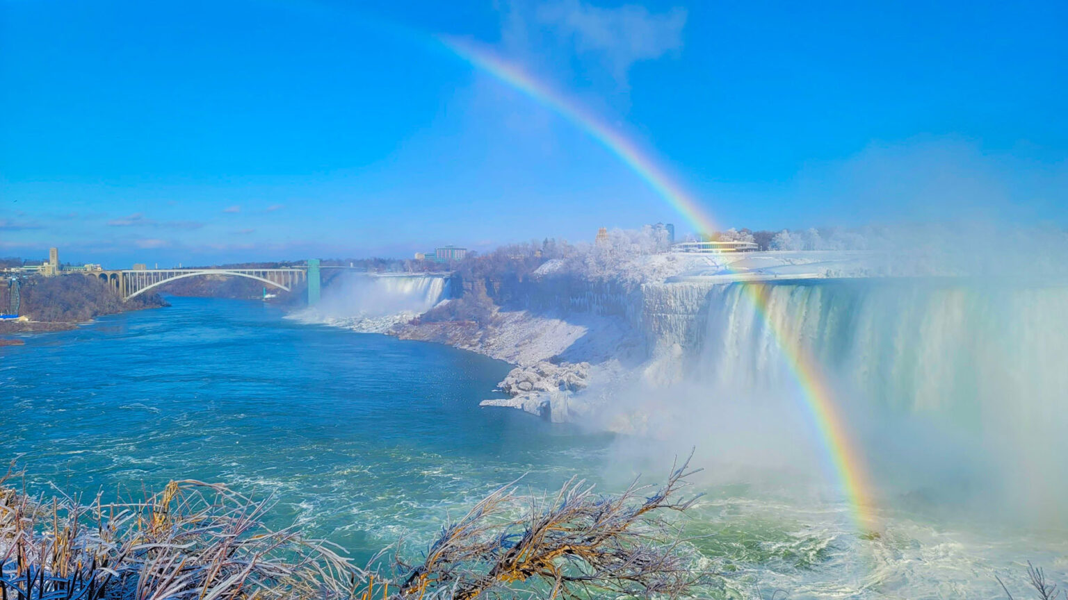 Mesmerizing view of beautiful winter landscape, rainbow over the Horseshoe Falls in Niagara Falls
