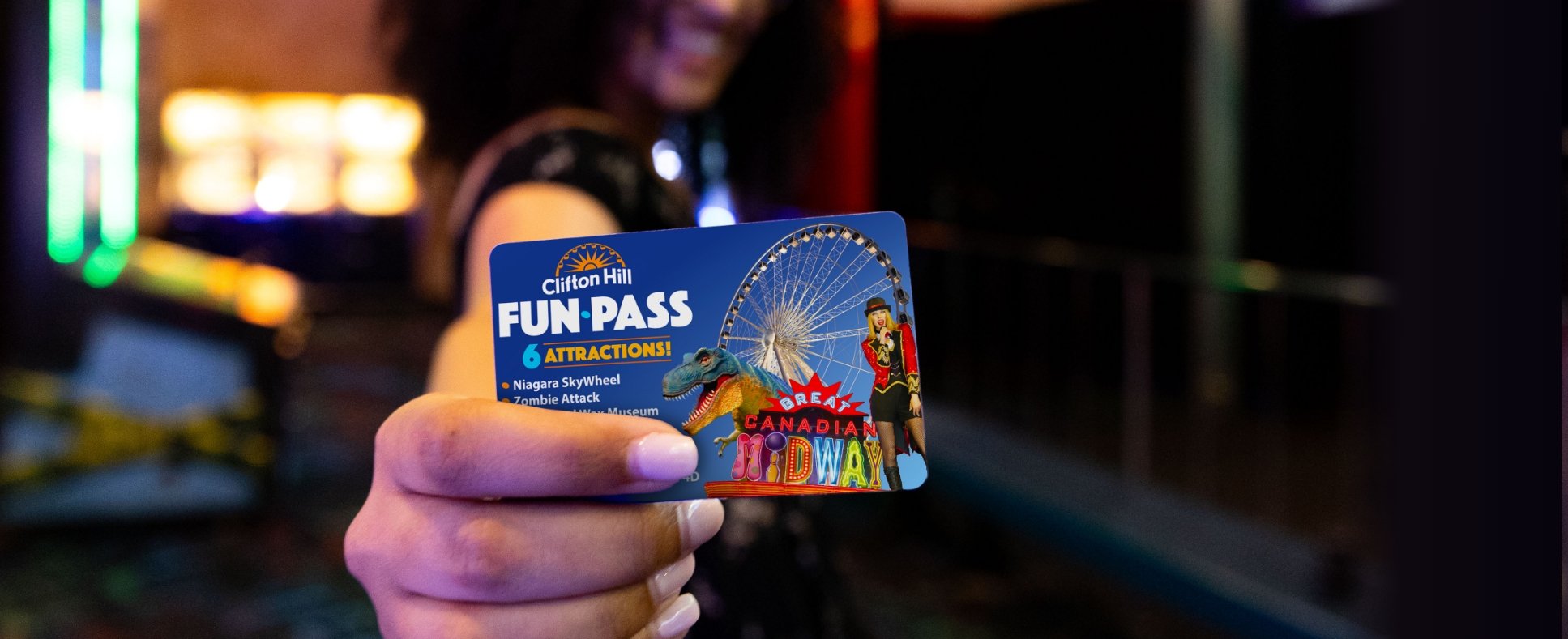 Woman Holding Up A Clifton Hill Fun Pass