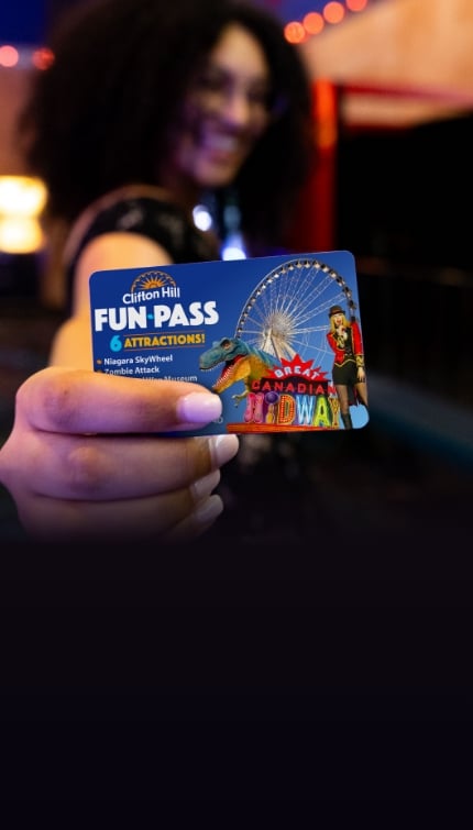 Woman Holding Up A Clifton Hill Fun Pass