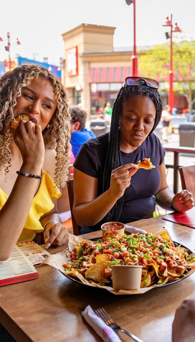 Friends Enjoying A Meal On A Patio