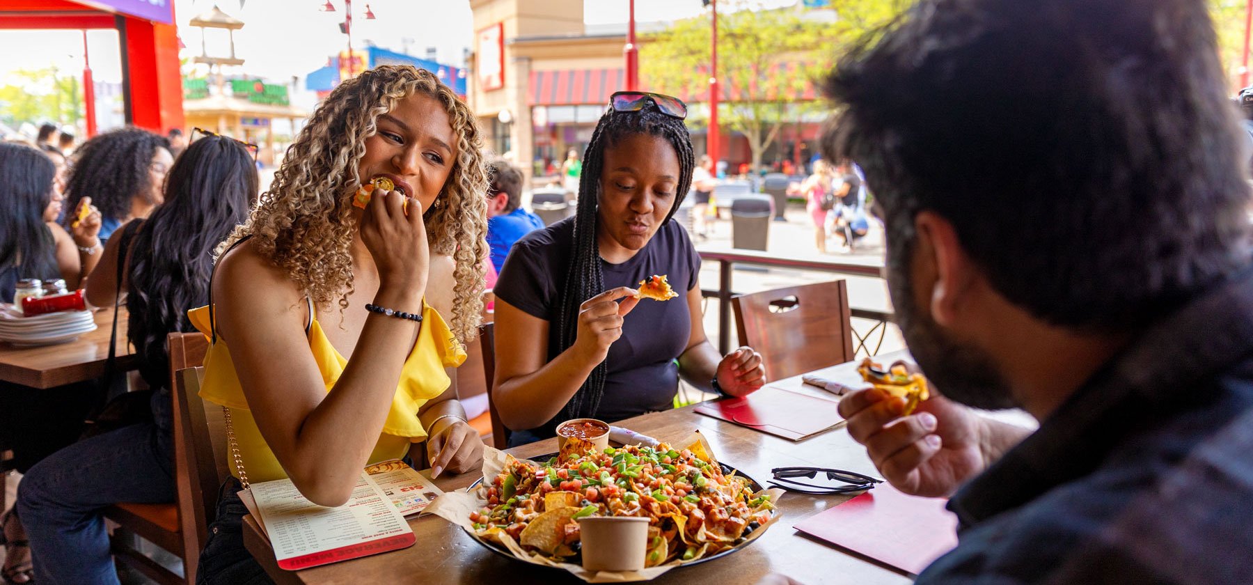 Friends Enjoying A Meal On A Patio