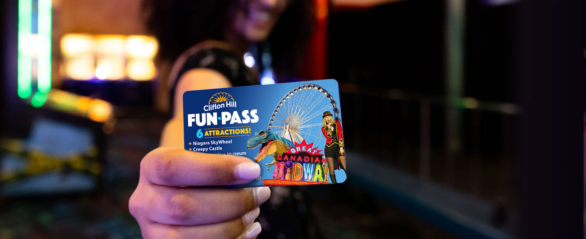 Woman Holding Up A Clifton Hill Fun Pass