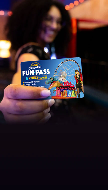 Woman Holding Up A Clifton Hill Fun Pass