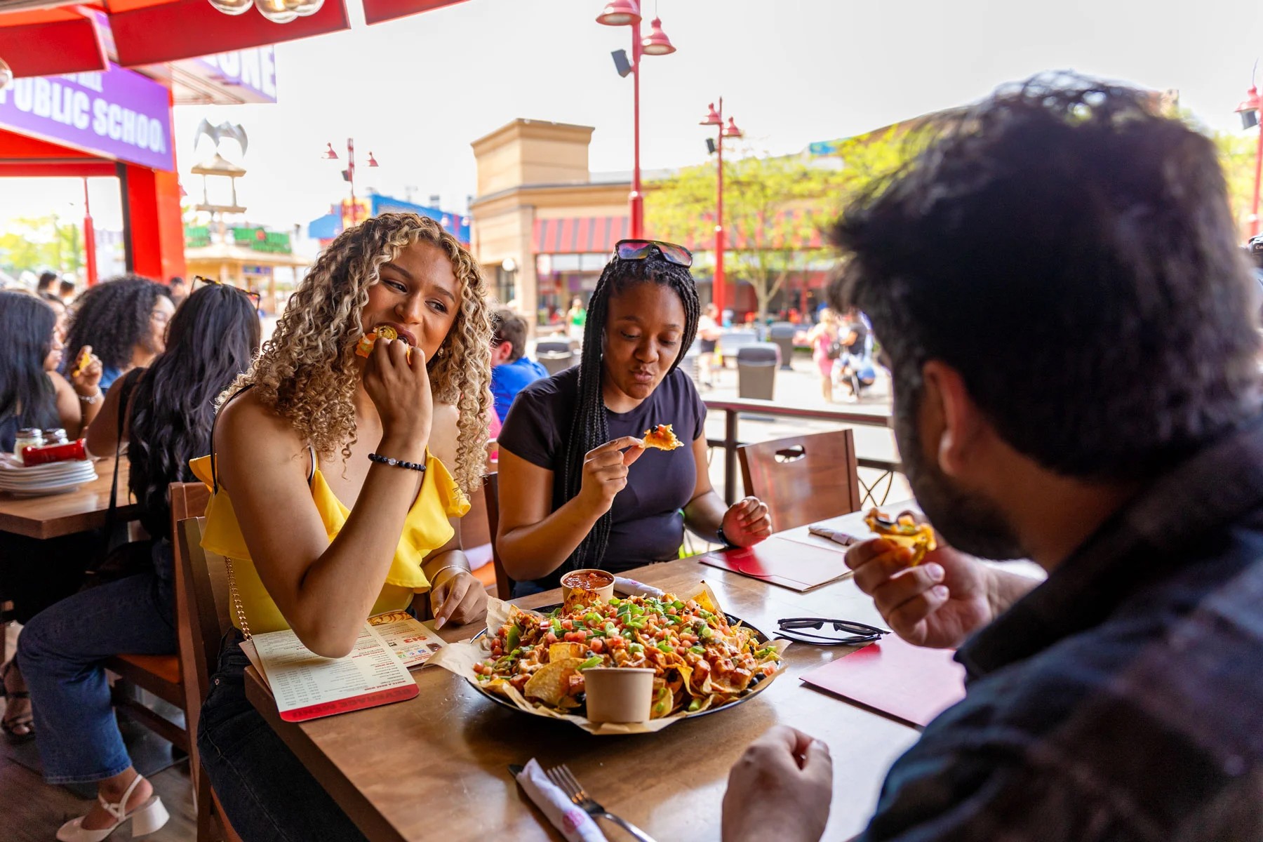 Friends Enjoying A Meal On A Patio