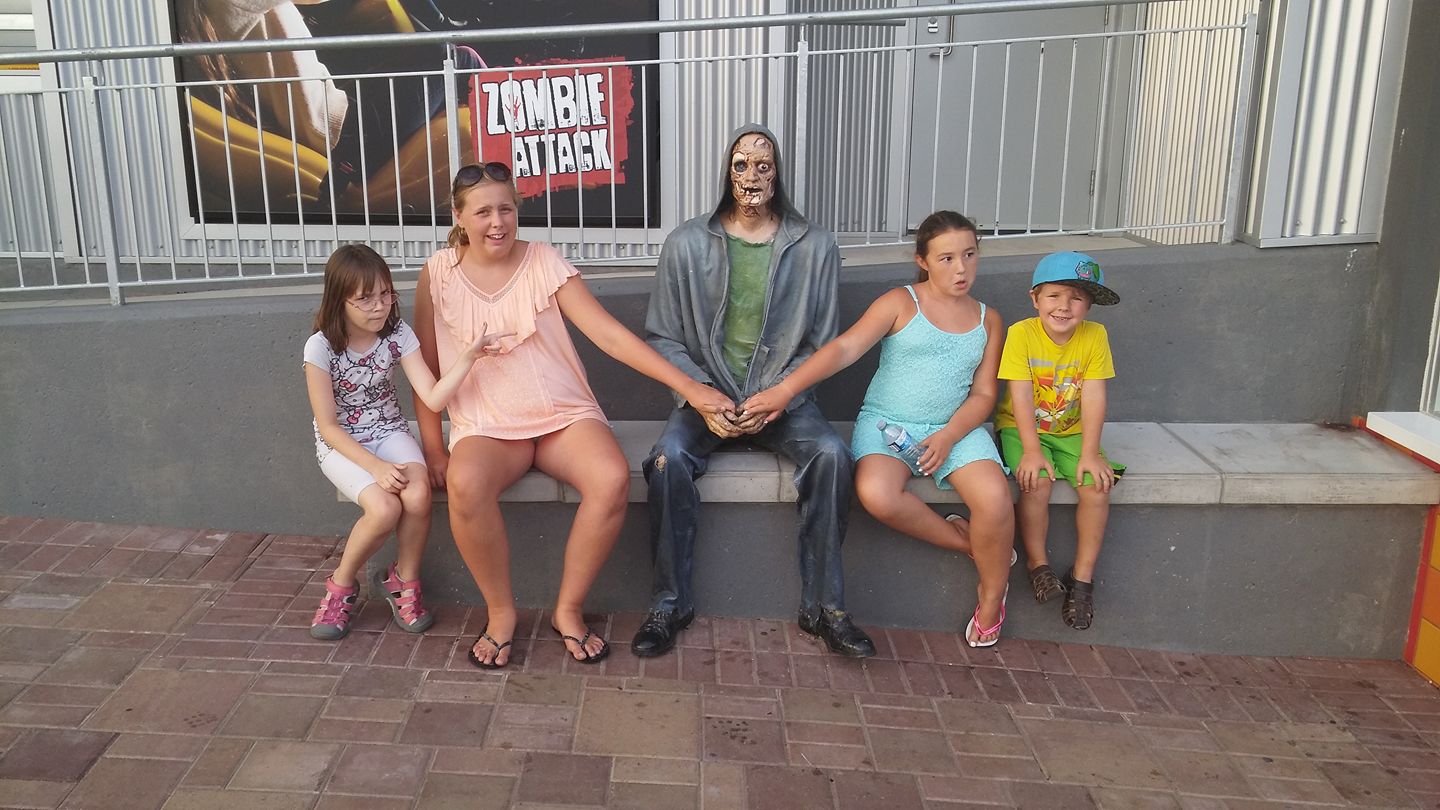 Amanda Carder and family sitting with Zombie dude