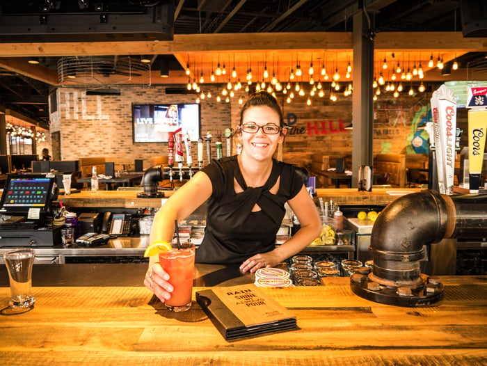 Kelsey's Bar Attendant Serving Drinks