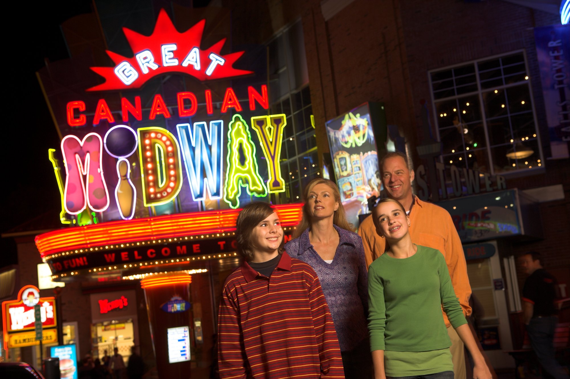 Family in front of Great Canadian Midway