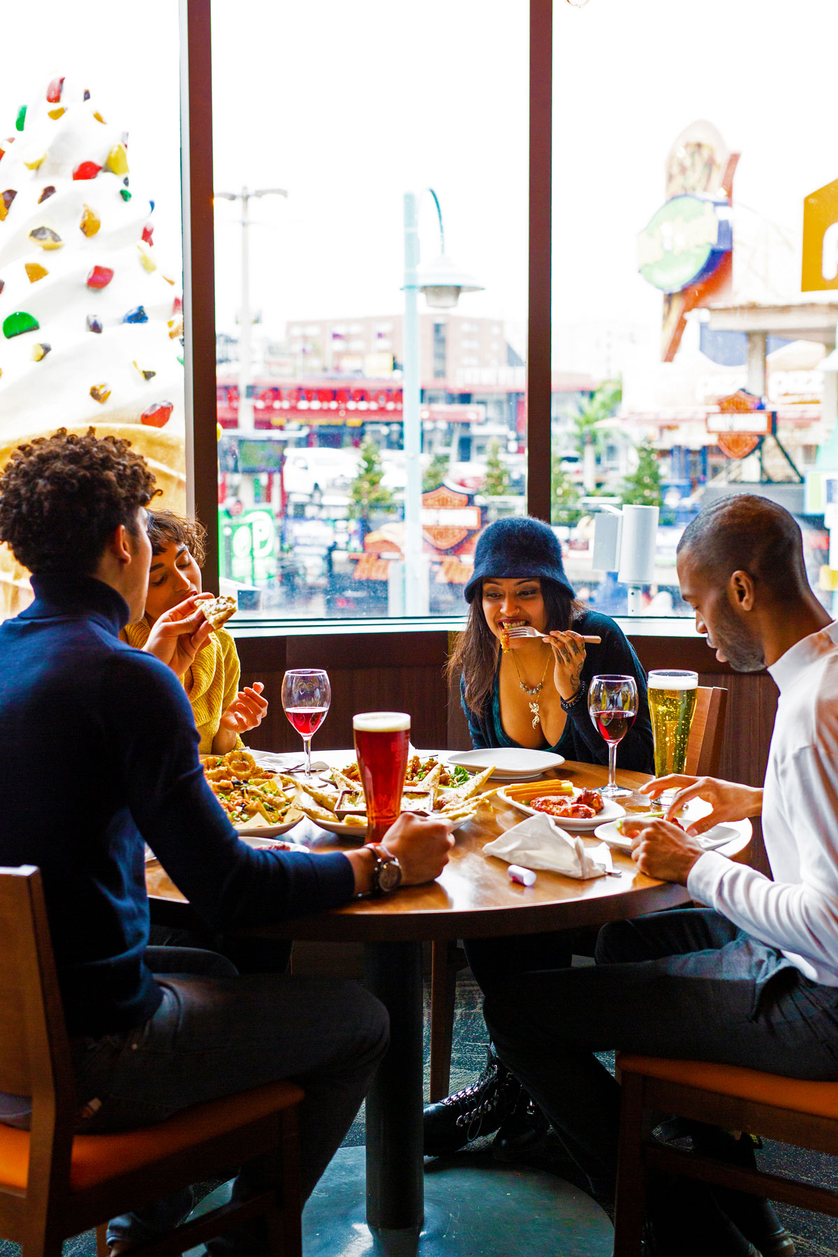 Friends enjoying food and drink on upper dining area