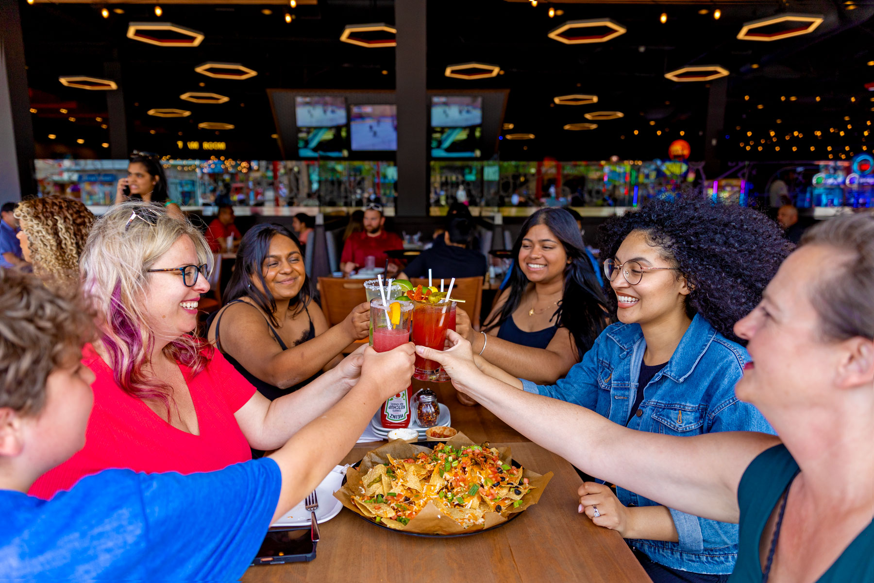 Group of people cheering on patio at Boston Pizza