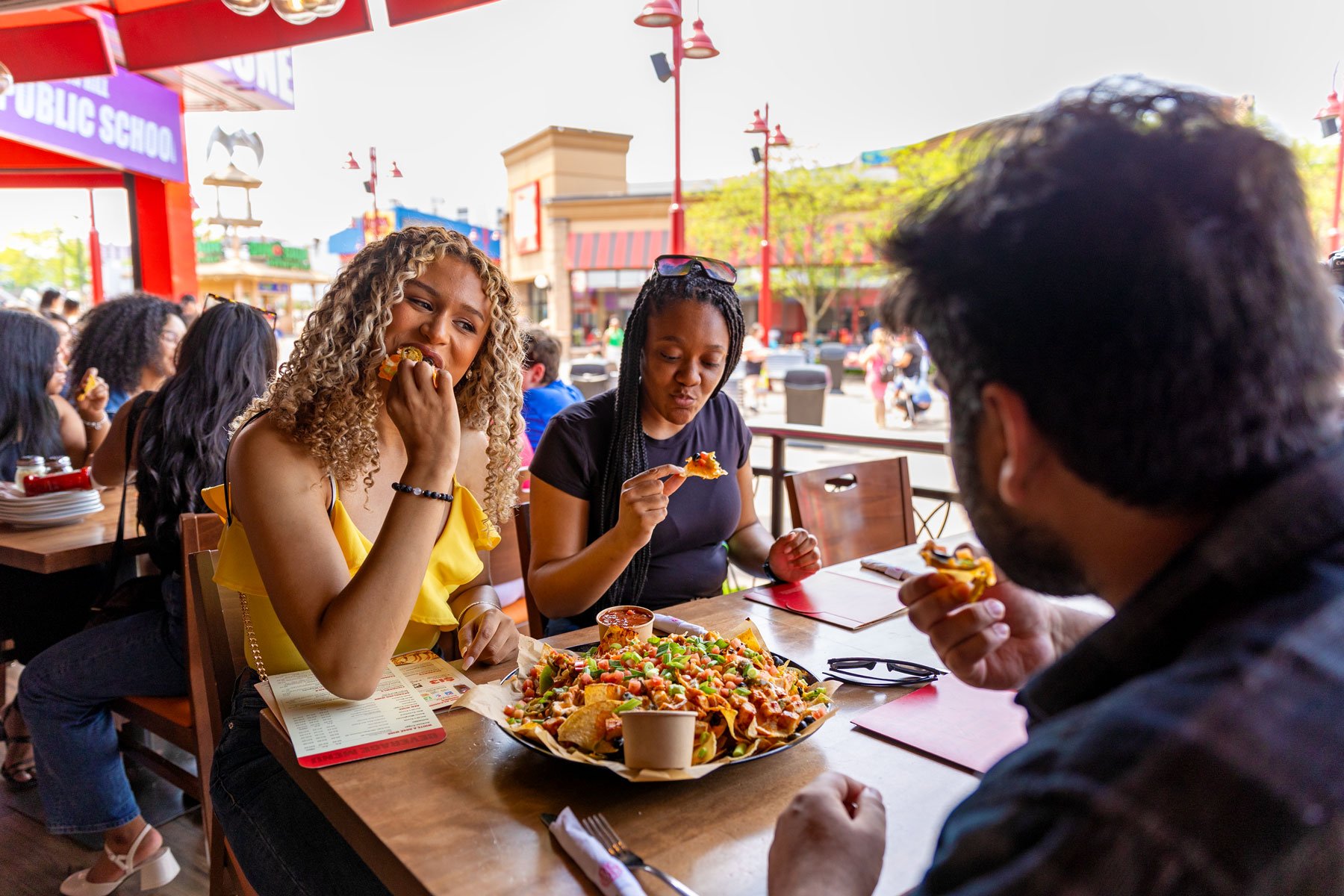 Group of young adults enjoying boston pizza's patio on clifton hill