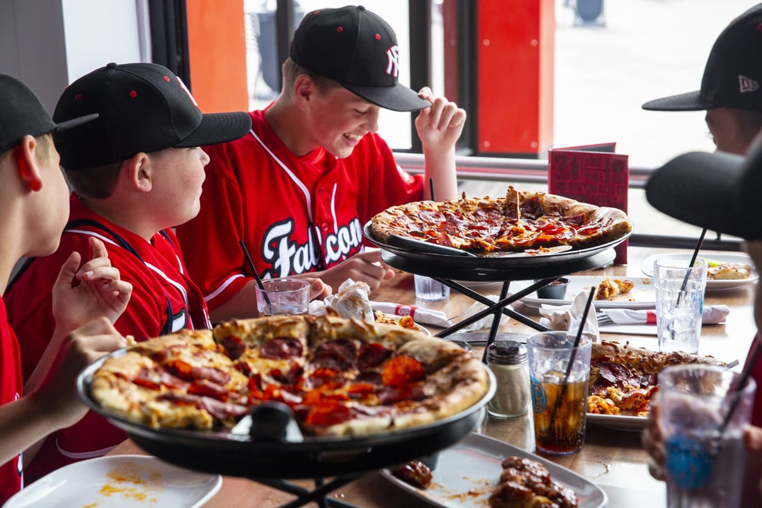 Baseball team feasting on pizza at BP