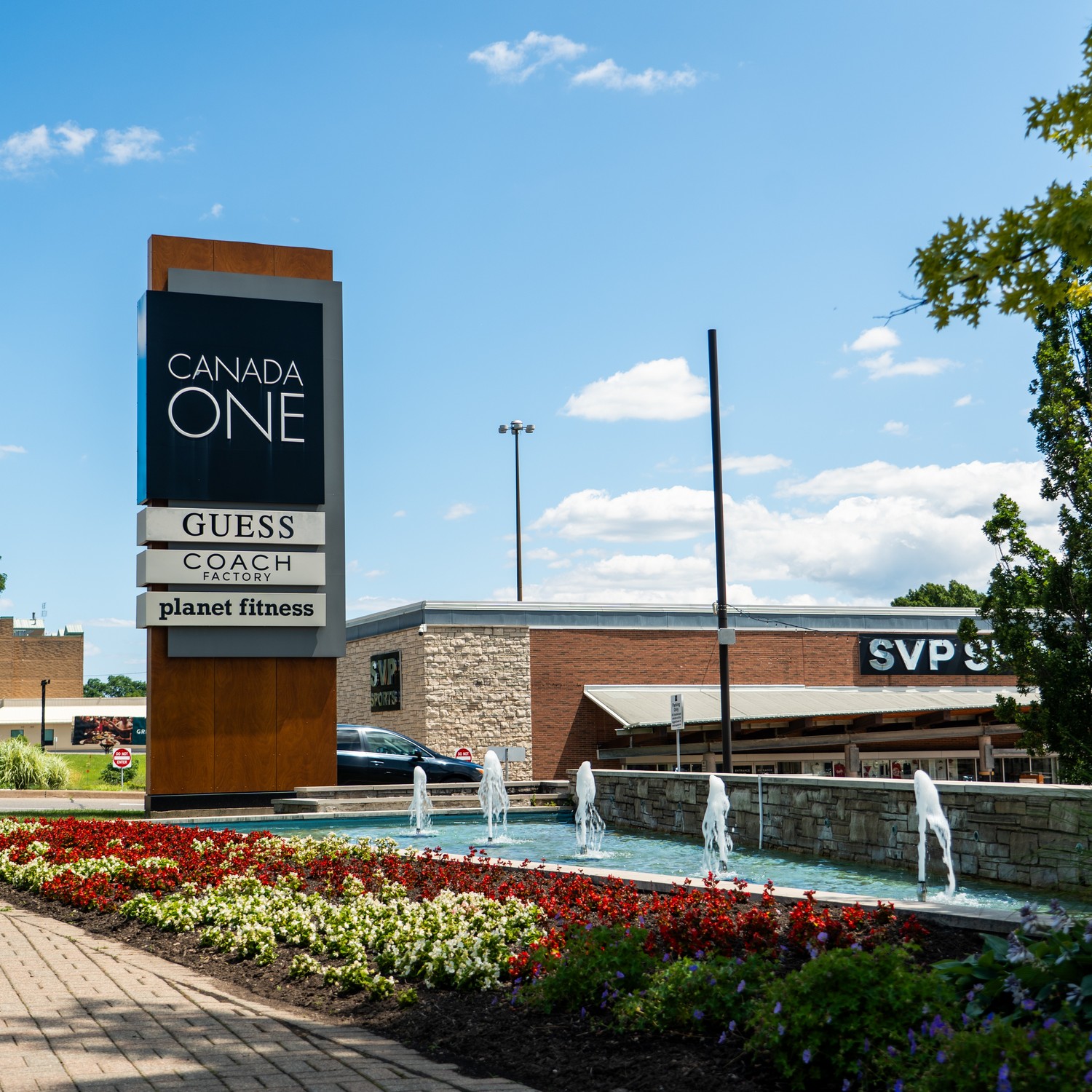Canada One Outlet on Lundys Lane featuring fountain, SVP, COACH, and Guess