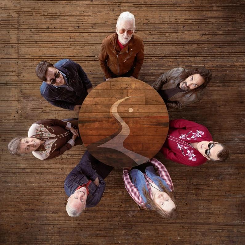 Blue Rodeo band members standing in a circle