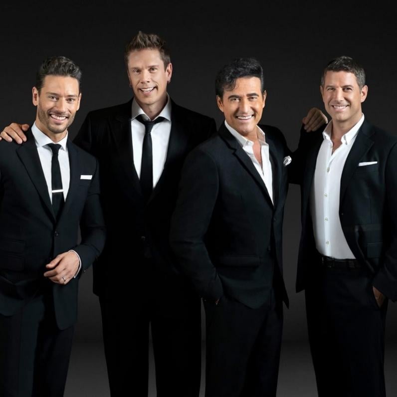 Four vocalists in black suits
