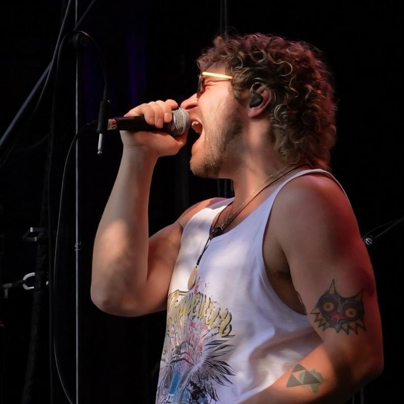 Kyle on stage with a mic in his hand