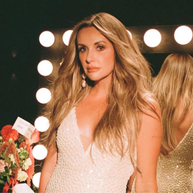 Carly standing in a dressing room 