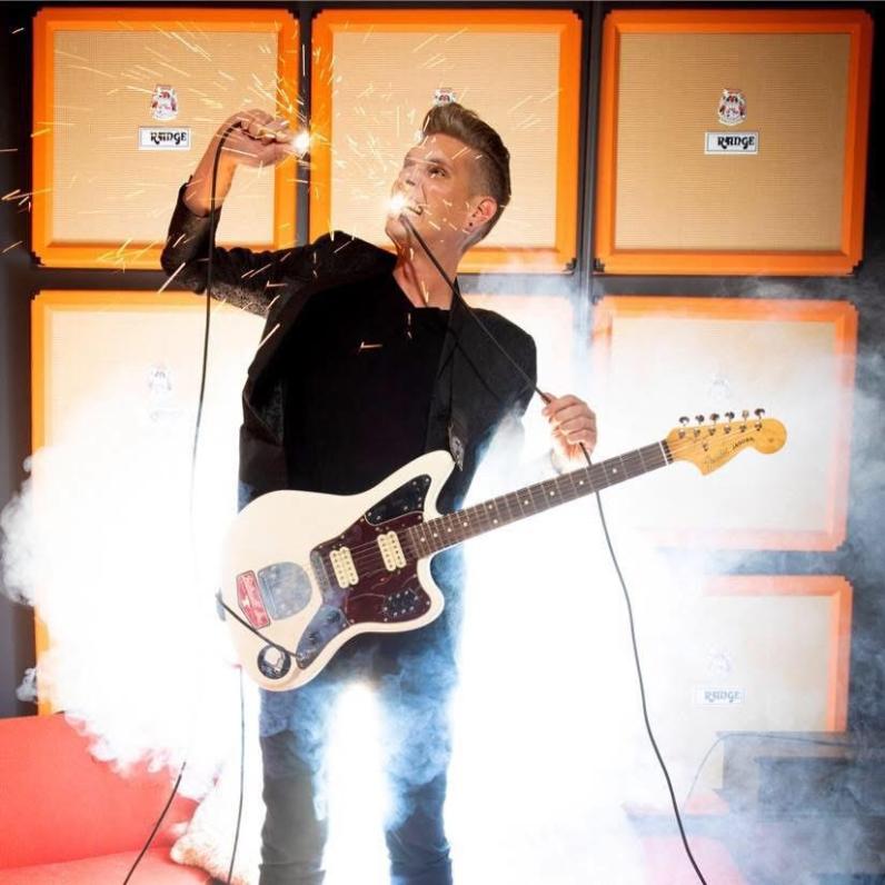 Chris Funk on stage with an electric guitar