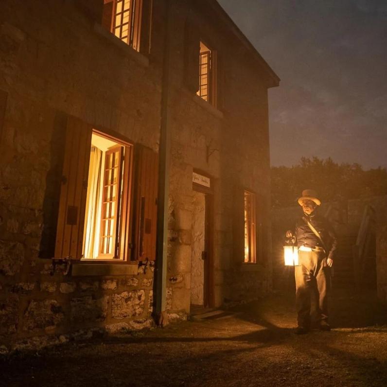 Man walking with a lamp in the dark 