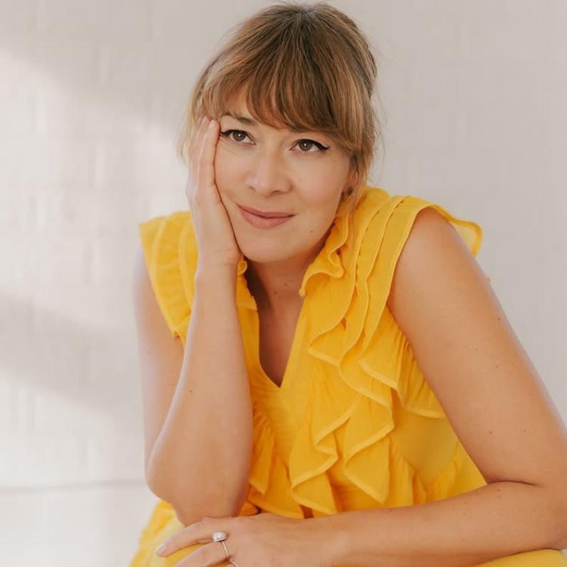 Jill Barber in a yellow sleeveless blouse