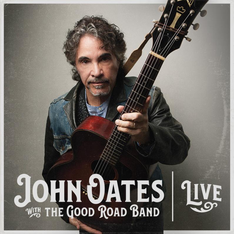 John Oates holding a guitar