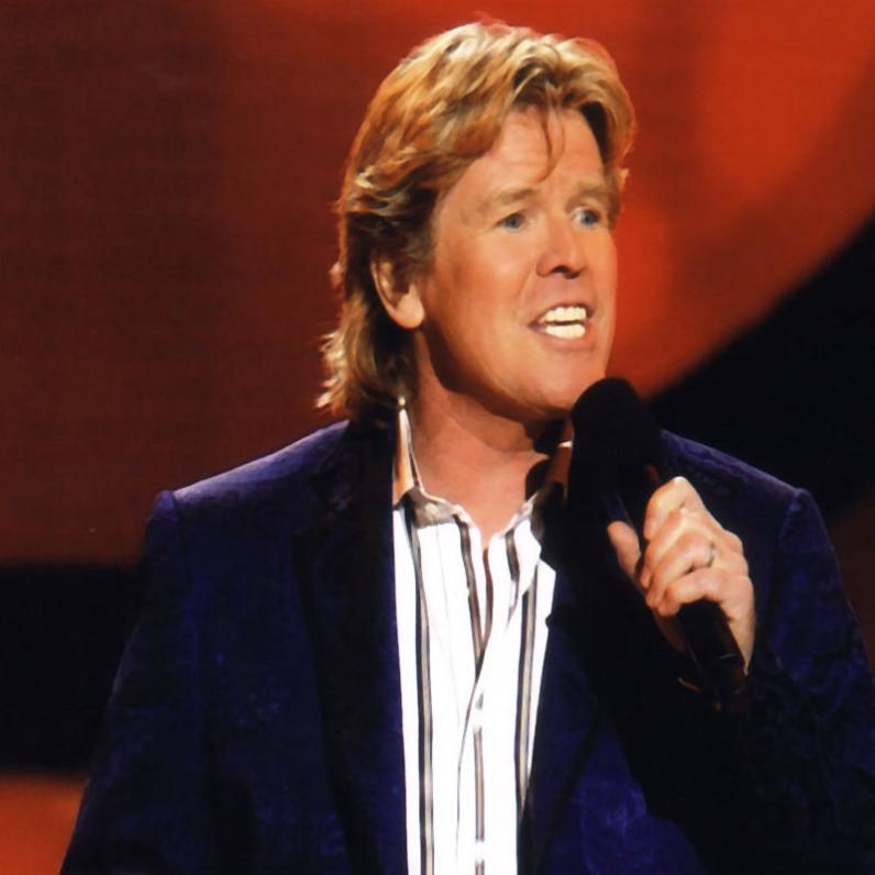 Peter Noone singing on stage