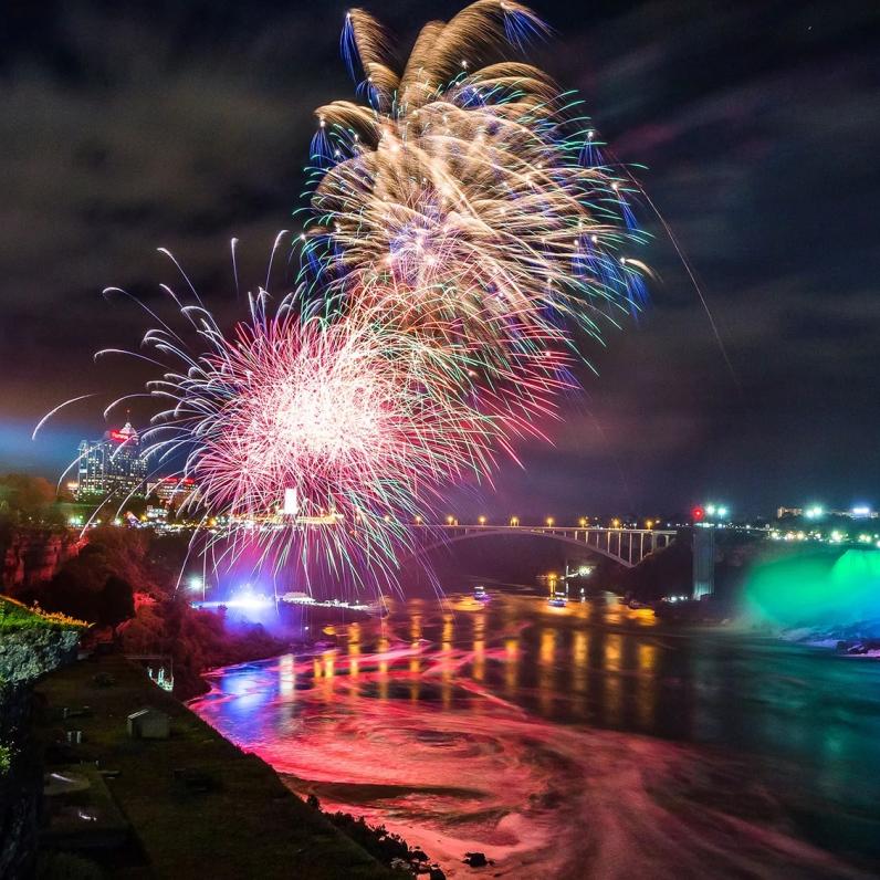 Fireworks over the falls with the Rainbowbridge, Sheraton Hotel, and Niagara SkyWheel in the background