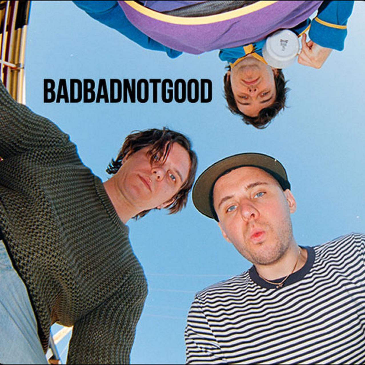 Three band members looking down at the camera