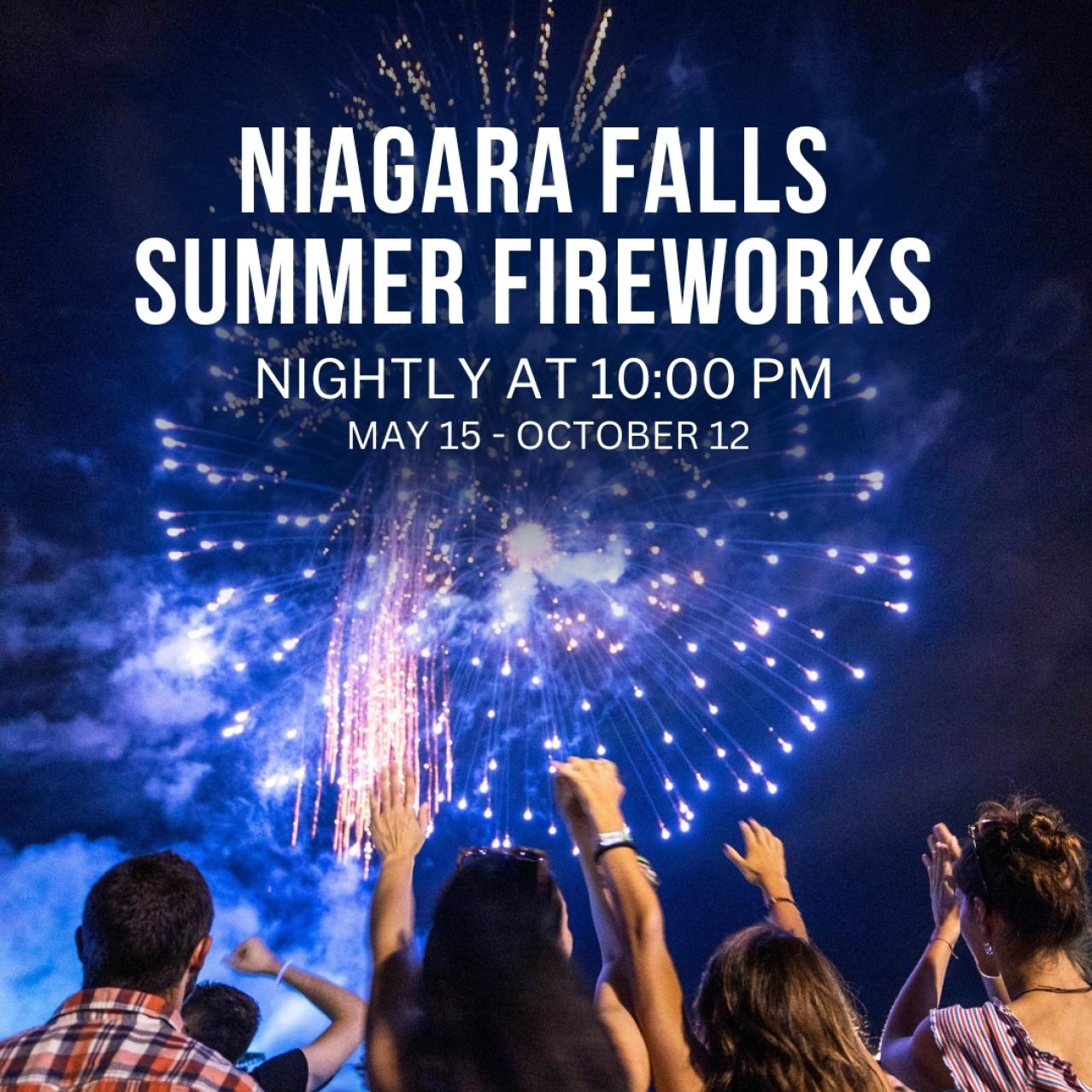 Four friends under the fireworks with their arms up in excitement