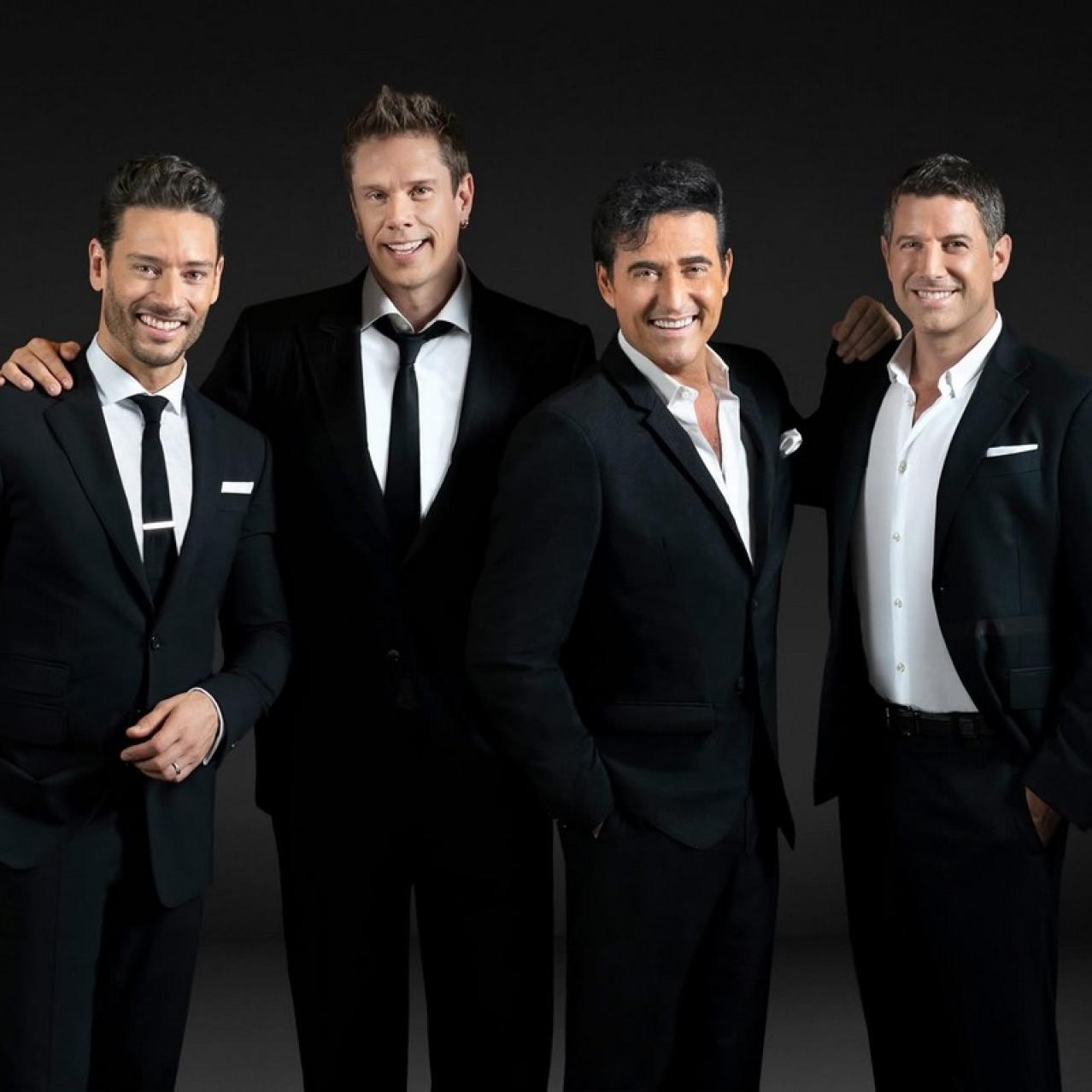 Four vocalists in black suits