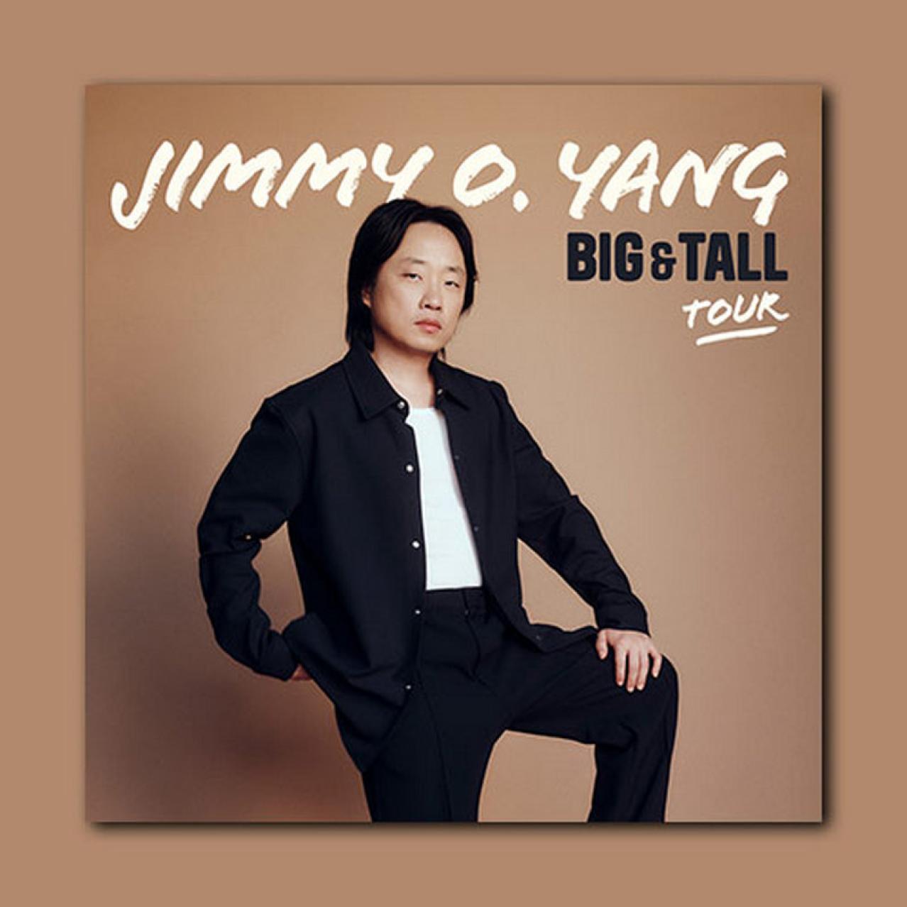 Jimmy stands dressed in black with white shirt