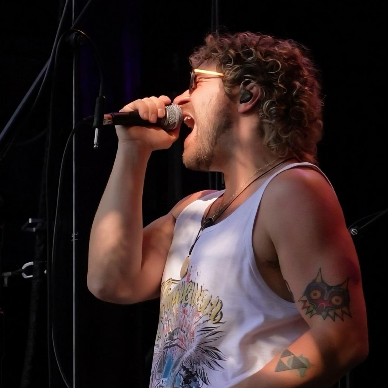 Kyle on stage with a mic in his hand