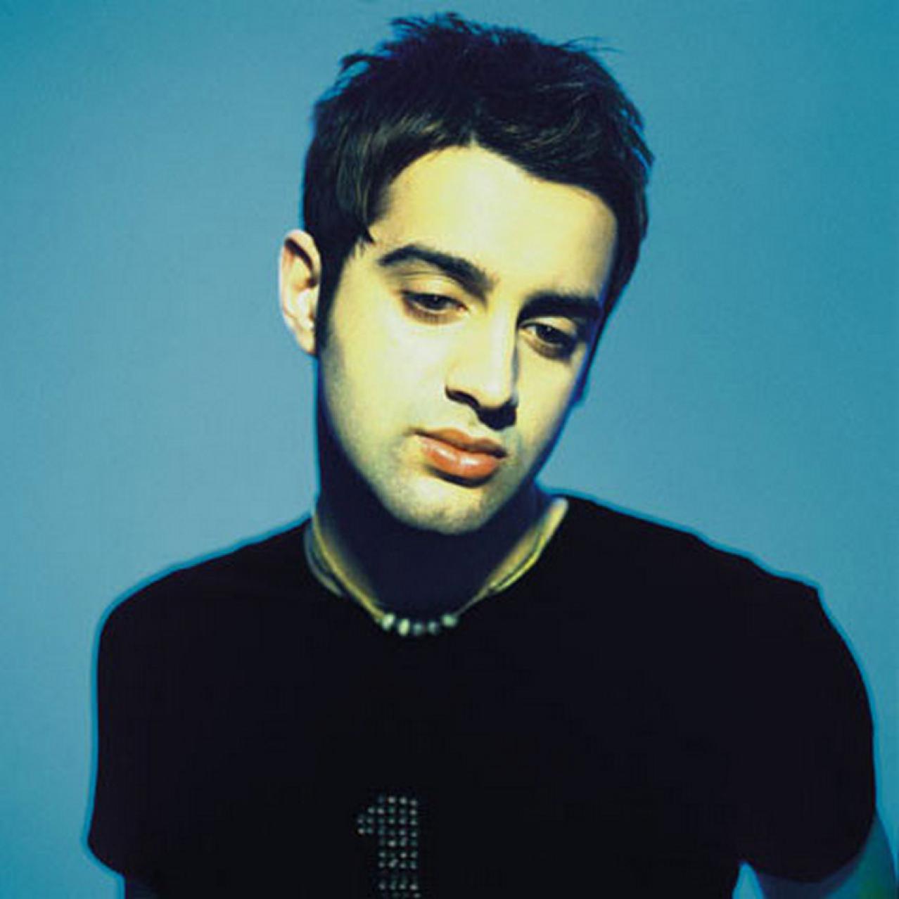 headshot of paul gigliotti with blue background