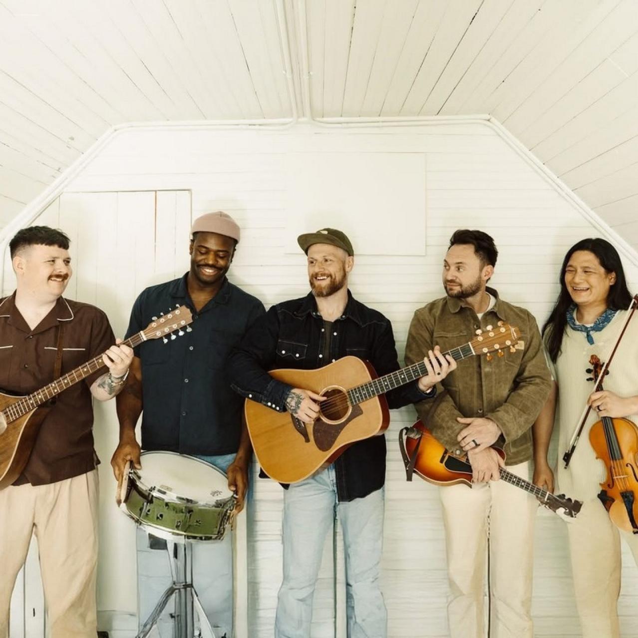 Rend Collective Band holding their instruments