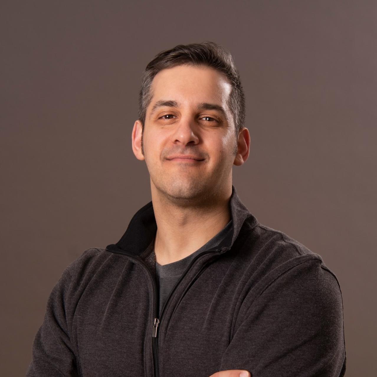 Chris Cicchino headshot with brown background