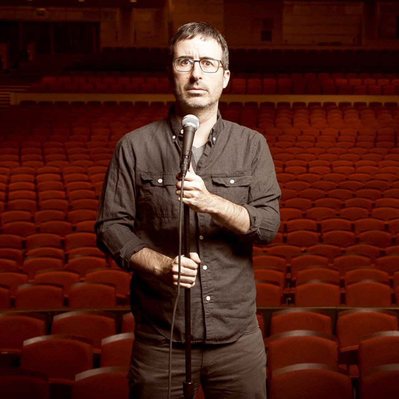 John Oliver inside empty theatre