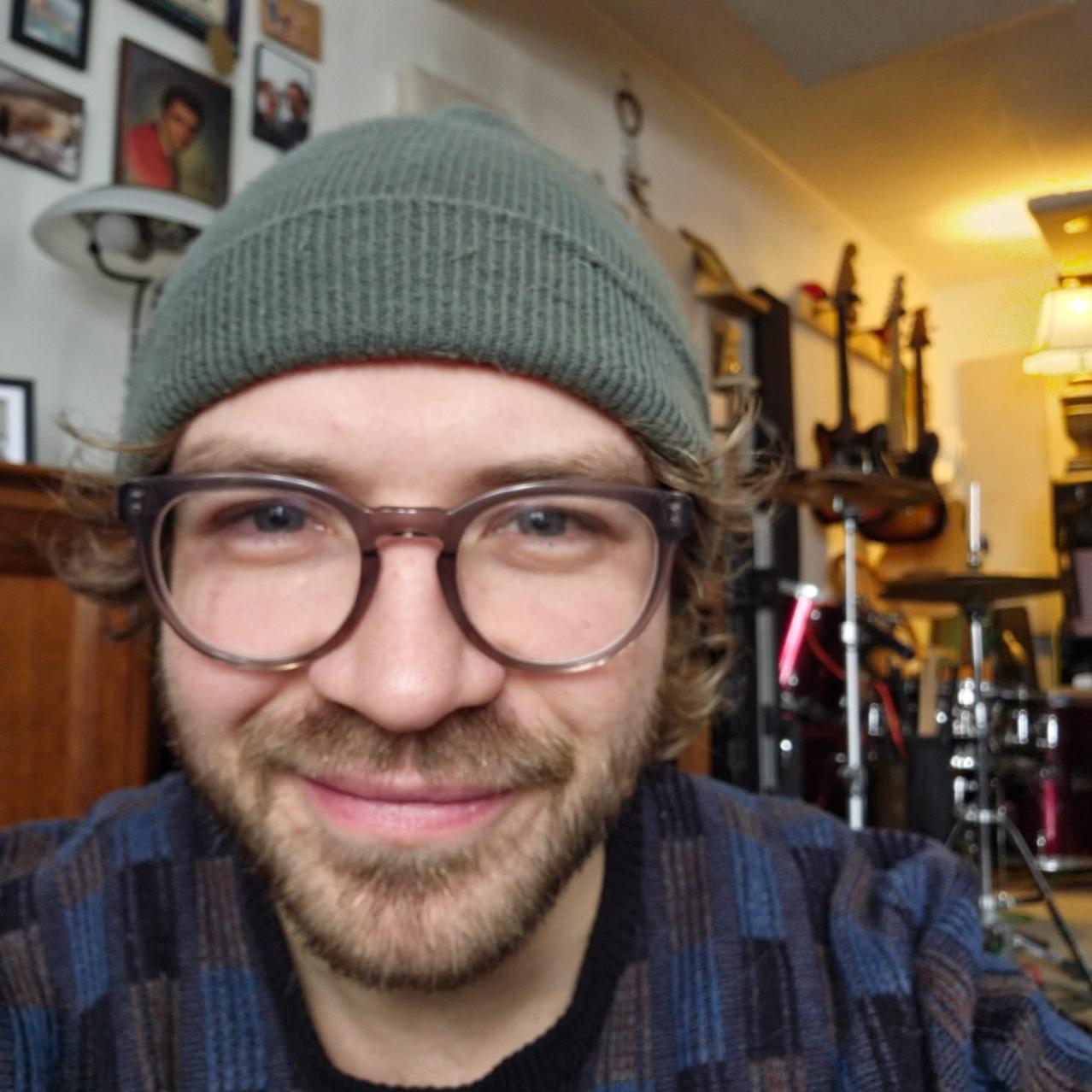 headshot of kyle mcdonnell with instruments in the background