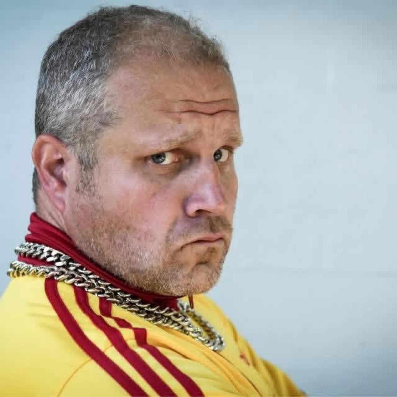 Byron Bertram in a yellow adidas shirt and a silver chain