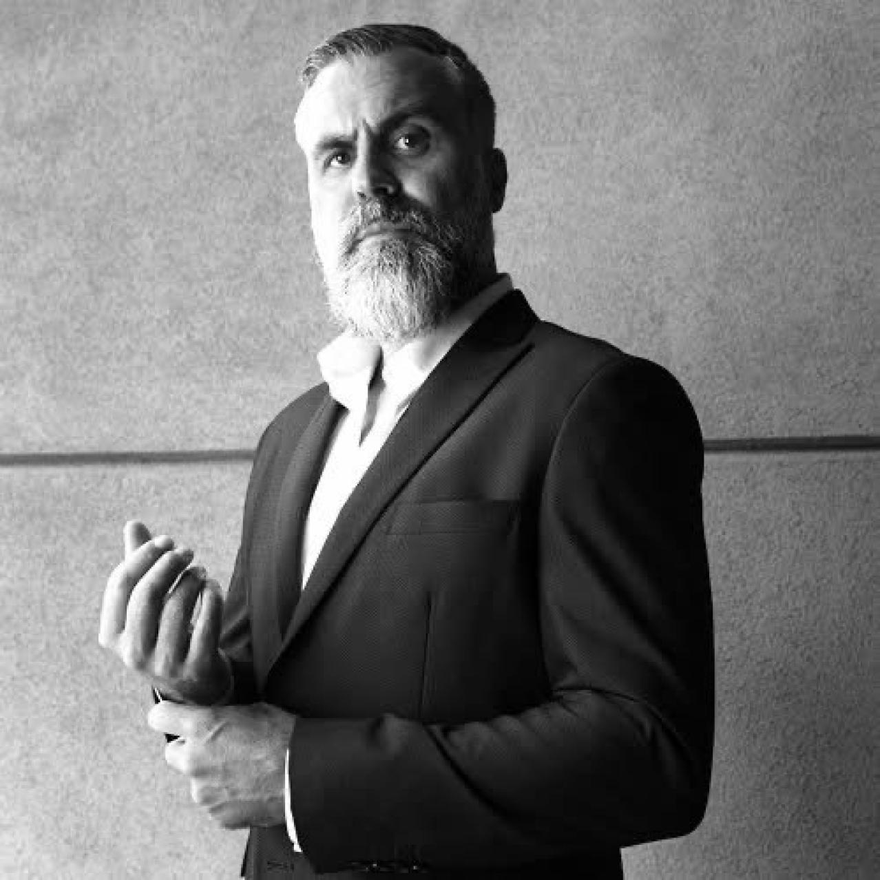 Nathan Warriner in a sports jacket black and white photo