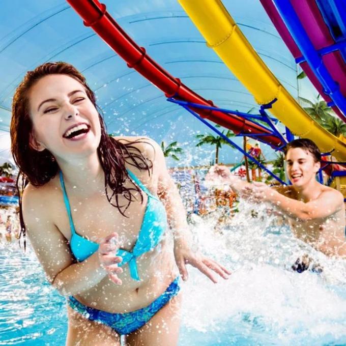 Girl in a blue bikini getting splashed by water
