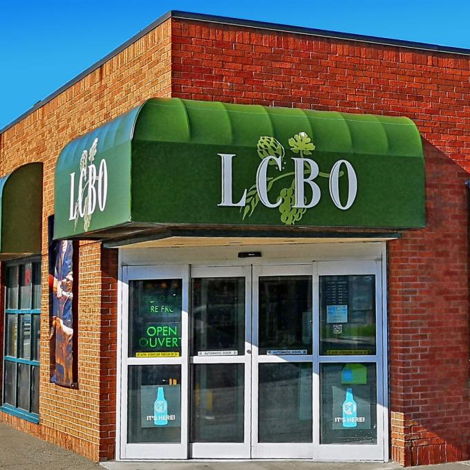 LCBO exterior Ferry Street Niagara Falls entrance with green signage and a red brick building